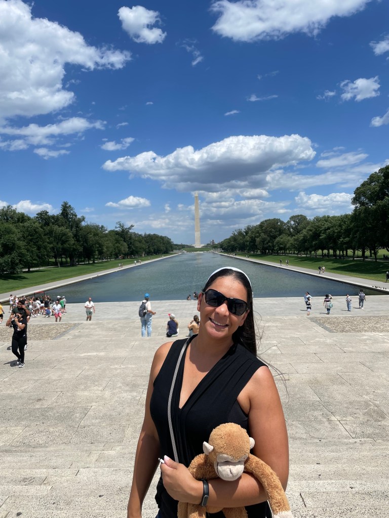 Zephora Travel advisor visiting Washington DC with the Washington Monument in the background